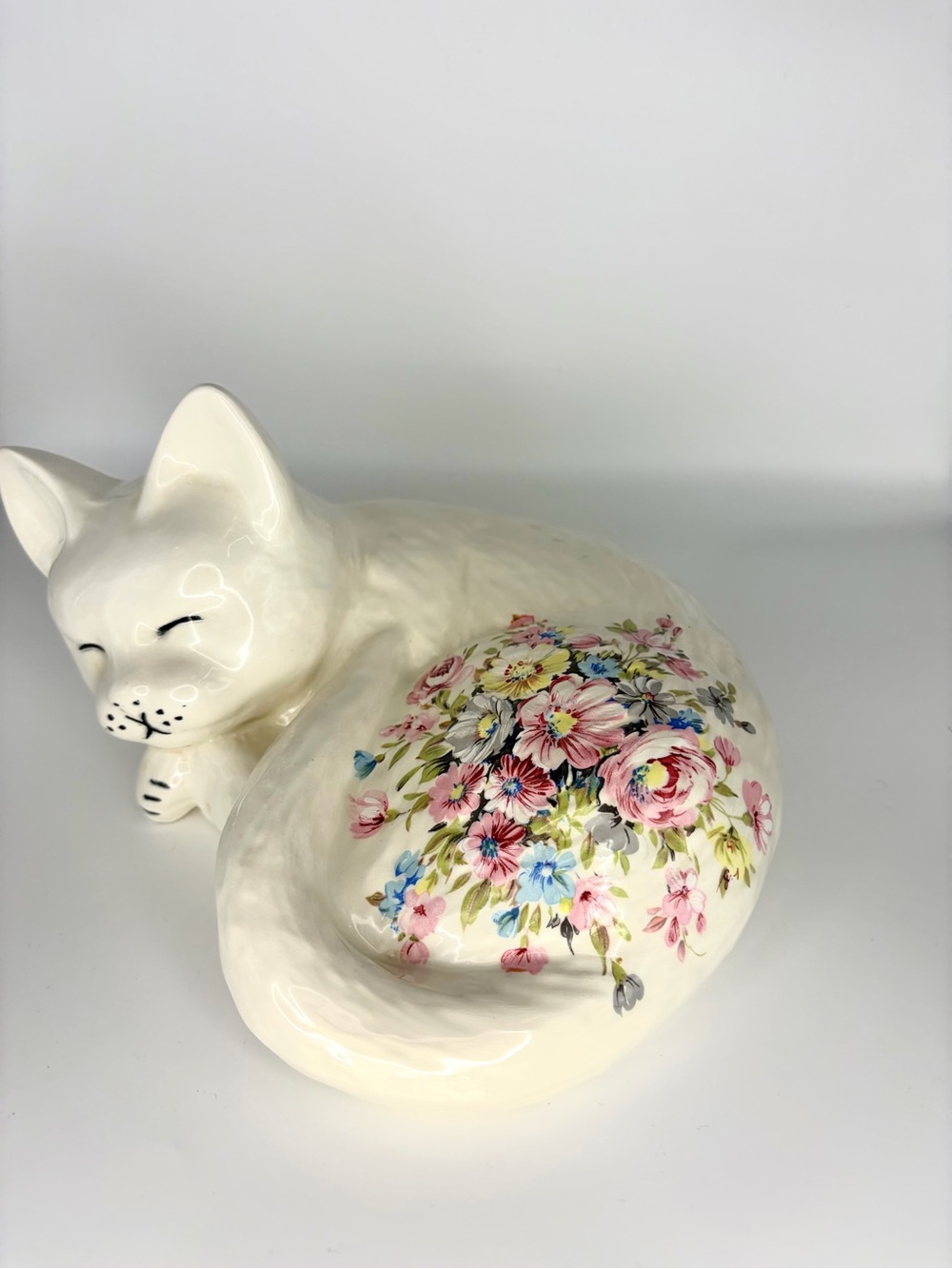 White Ceramic Sleeping Cat with Floral Accent